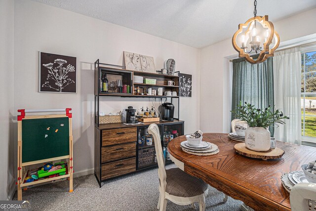 dining space featuring light carpet, baseboards, and an inviting chandelier