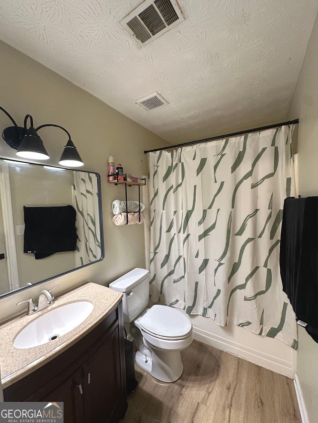 2900 Haddon Dr, Rex, GA 30273 - full bathroom with wood finished floors, vanity, a textured ceiling, and shower / bath combo with shower curtain