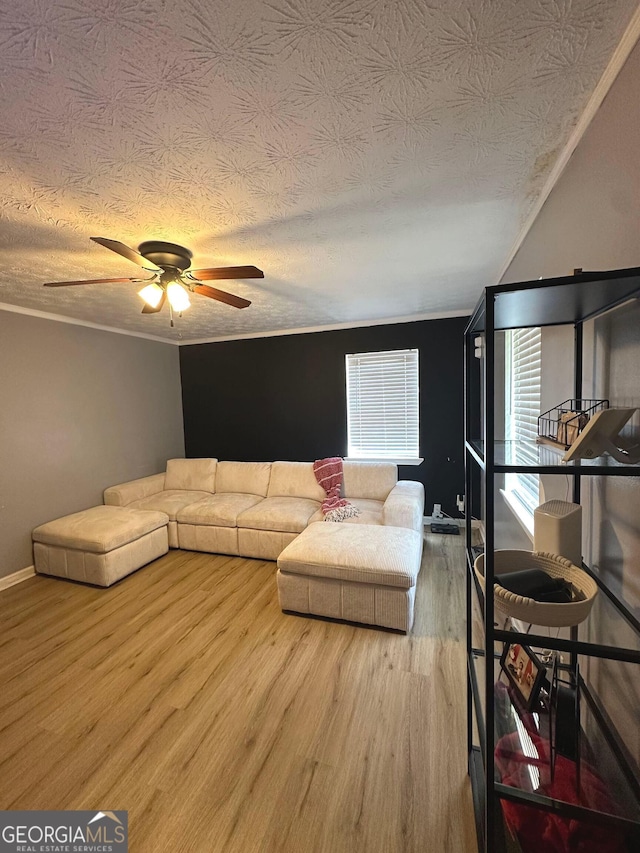 2900 Haddon Dr, Rex, GA 30273 - living room featuring a textured ceiling, wood finished floors, ceiling fan, and ornamental molding