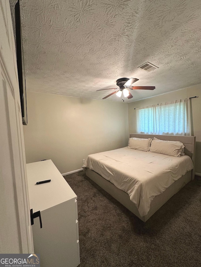 2900 Haddon Dr, Rex, GA 30273 - bedroom with dark colored carpet, ceiling fan, and a textured ceiling