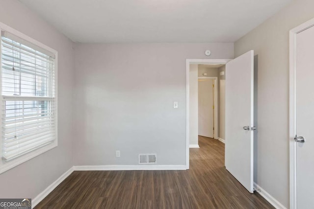 121 Hillsdale Dr SE, Atlanta, GA 30315 - spare room with dark wood finished floors and a smoke detector