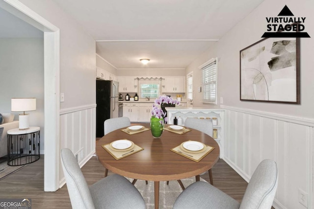 121 Hillsdale Dr SE, Atlanta, GA 30315 - dining area featuring wood finished floors, wainscoting, and a decorative wall