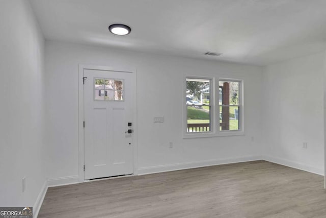 1318 Graymont Dr SW, Atlanta, GA 30310 - entrance foyer featuring baseboards, light wood finished floors, visible vents, and plenty of natural light