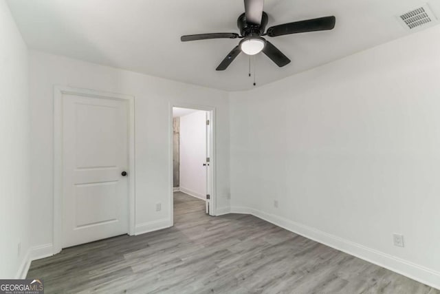 1318 Graymont Dr SW, Atlanta, GA 30310 - unfurnished bedroom with a ceiling fan, wood finished floors, baseboards, and visible vents
