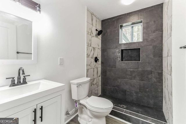 1318 Graymont Dr SW, Atlanta, GA 30310 - full bath with toilet, tiled shower, vanity, and wood finished floors
