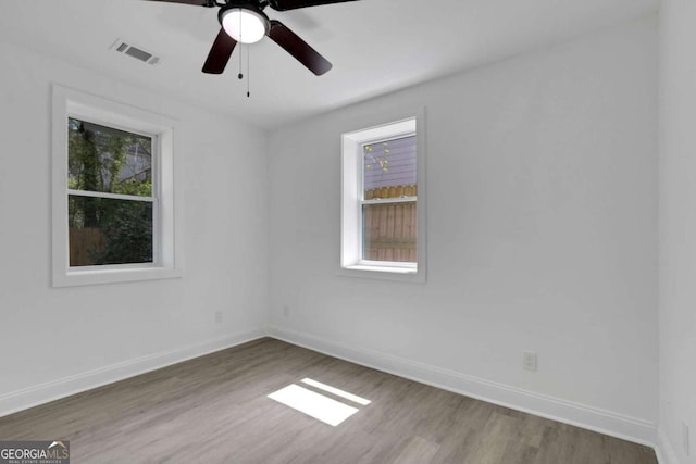 1318 Graymont Dr SW, Atlanta, GA 30310 - empty room with baseboards, visible vents, a ceiling fan, and wood finished floors