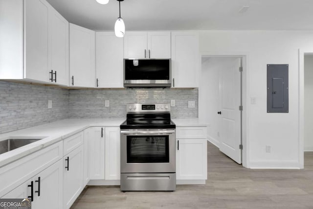 1318 Graymont Dr SW, Atlanta, GA 30310 - kitchen with electric range, light wood-style flooring, white cabinetry, and electric panel