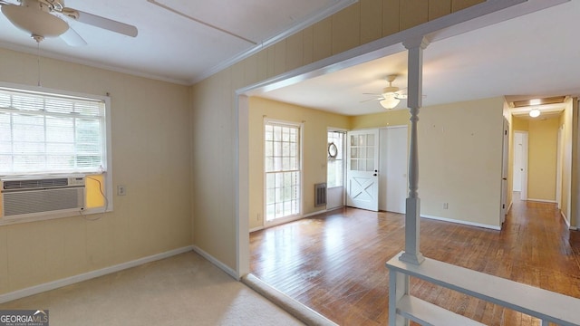 unfurnished room featuring a ceiling fan, baseboards, and plenty of natural light