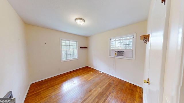 unfurnished room featuring baseboards, plenty of natural light, and light wood finished floors