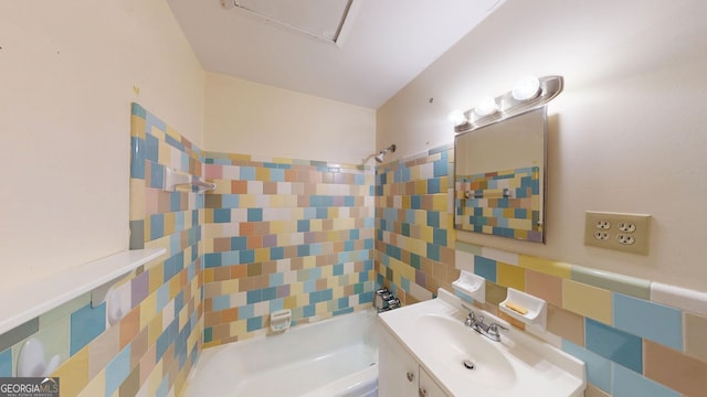 bathroom featuring vanity, tub / shower combination, and tile walls