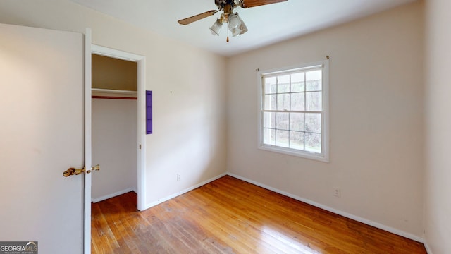 unfurnished bedroom with light wood-style floors, baseboards, a ceiling fan, and a closet