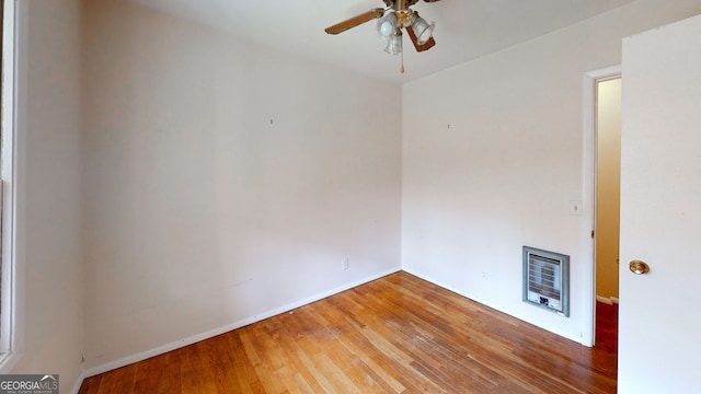 empty room featuring baseboards, ceiling fan, and wood finished floors