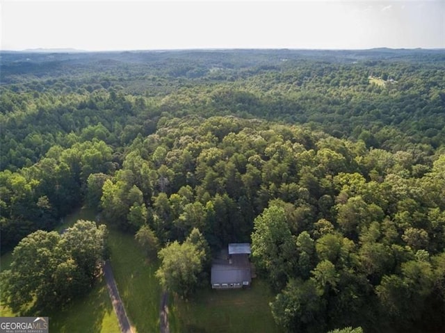 birds eye view of property featuring a view of trees