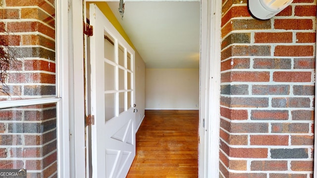 doorway to property with brick siding