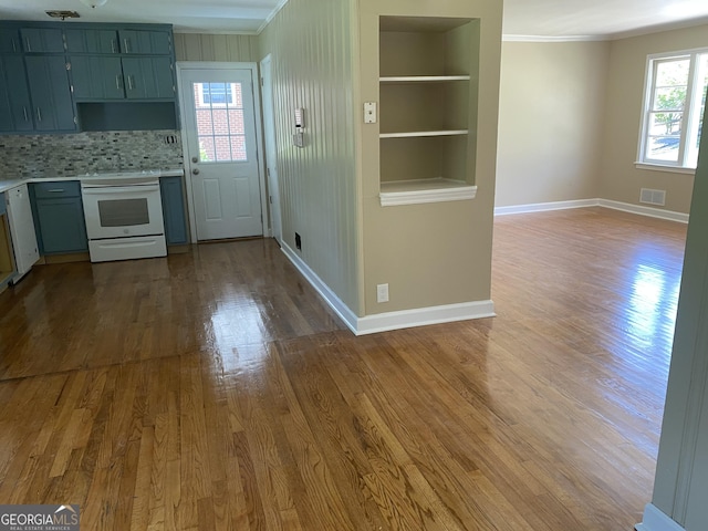 2502 Miriam Ln, Decatur, GA 30032 - kitchen featuring white range with electric cooktop, light countertops, baseboards, wood finished floors, and ornamental molding