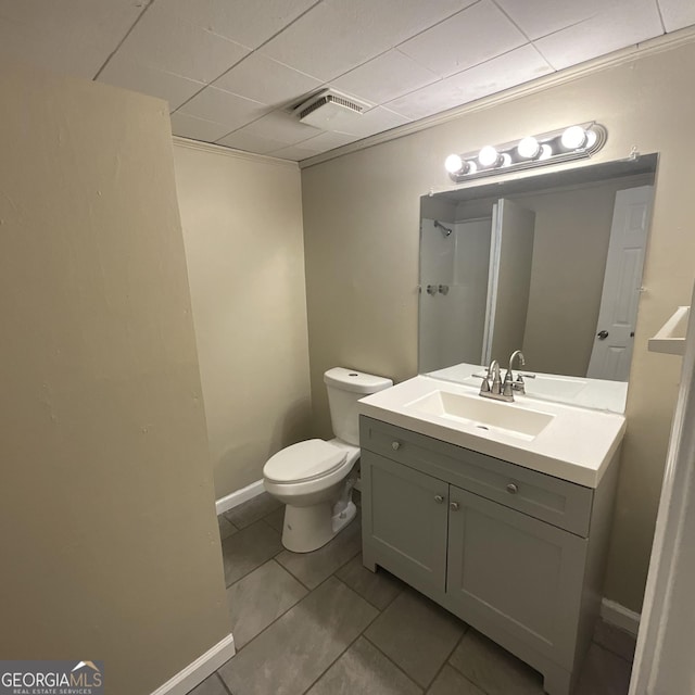 2502 Miriam Ln, Decatur, GA 30032 - full bathroom featuring toilet, vanity, a paneled ceiling, baseboards, and a shower