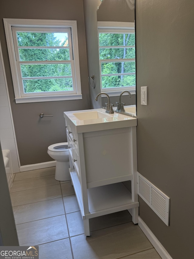 2502 Miriam Ln, Decatur, GA 30032 - bathroom with vanity, baseboards, toilet, a bathtub, and tile patterned flooring