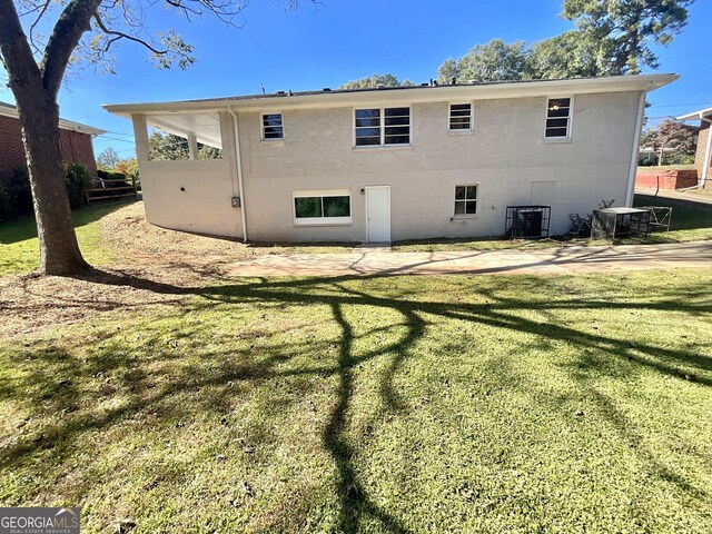 2502 Miriam Ln, Decatur, GA 30032 - rear view of house featuring a lawn, a patio area, and central AC
