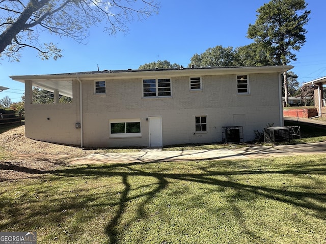 2502 Miriam Ln, Decatur, GA 30032 - rear view of property featuring a yard, brick siding, and central AC