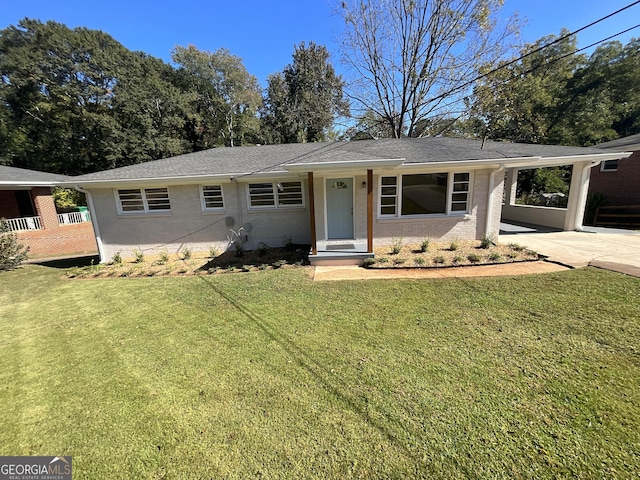 2502 Miriam Ln, Decatur, GA 30032 - view of front facade with a front lawn, an attached carport, driveway, brick siding, and a shingled roof