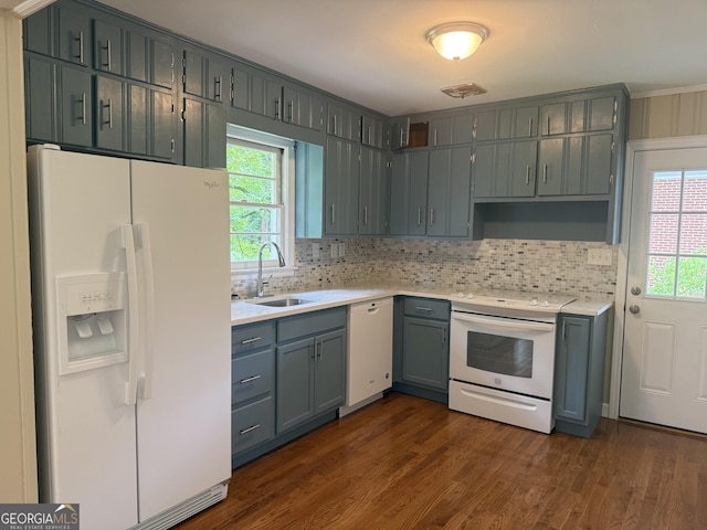 2502 Miriam Ln, Decatur, GA 30032 - kitchen with white appliances, a sink, dark wood finished floors, light countertops, and backsplash