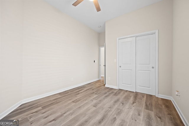 556 James P Brawley Dr NW, Atlanta, GA 30318 - unfurnished bedroom featuring wood finished floors, a closet, and a ceiling fan
