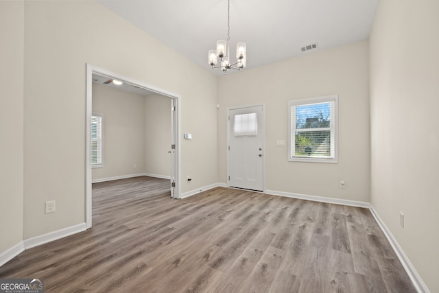 556 James P Brawley Dr NW, Atlanta, GA 30318 - foyer featuring a chandelier and wood finished floors