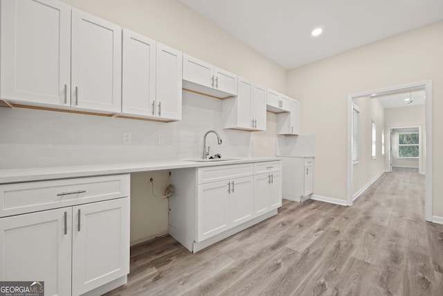 556 James P Brawley Dr NW, Atlanta, GA 30318 - kitchen featuring light wood finished floors, recessed lighting, decorative backsplash, and white cabinetry