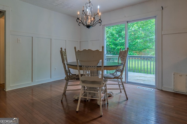 210 Briarwood Dr, Dallas, GA 30132 - dining space featuring a decorative wall, a chandelier, wood-type flooring, and wainscoting