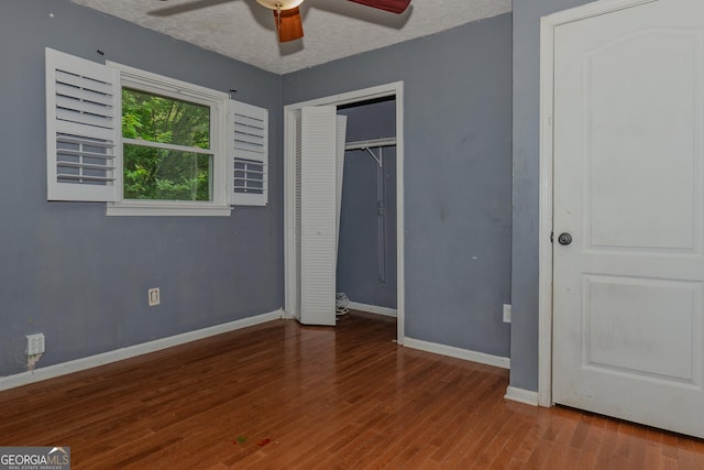 210 Briarwood Dr, Dallas, GA 30132 - unfurnished bedroom featuring baseboards, wood finished floors, a closet, and ceiling fan