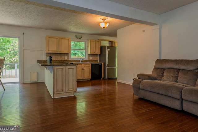 210 Briarwood Dr, Dallas, GA 30132 - kitchen with black dishwasher, freestanding refrigerator, open floor plan, dark countertops, and light brown cabinets
