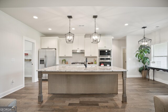 8 Hardin Ct Lot 16, Newnan, GA 30263 - kitchen with appliances with stainless steel finishes, under cabinet range hood, a breakfast bar area, white cabinets, and recessed lighting