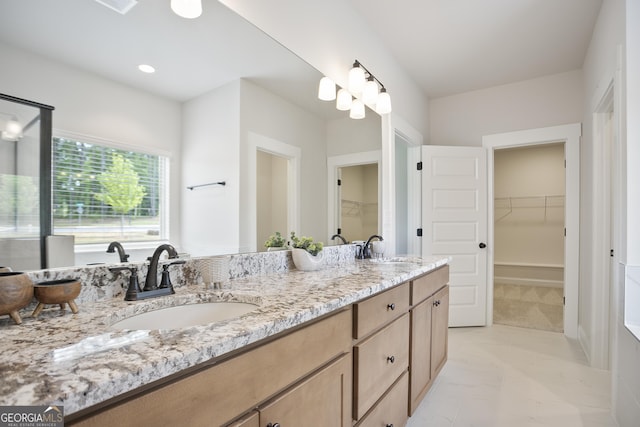 8 Hardin Ct Lot 16, Newnan, GA 30263 - full bathroom featuring marble look tile flooring, double vanity, a walk in closet, and a shower with shower door