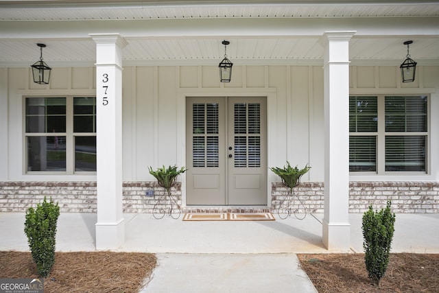 8 Hardin Ct Lot 16, Newnan, GA 30263 - doorway to property featuring board and batten siding, covered porch, and brick siding