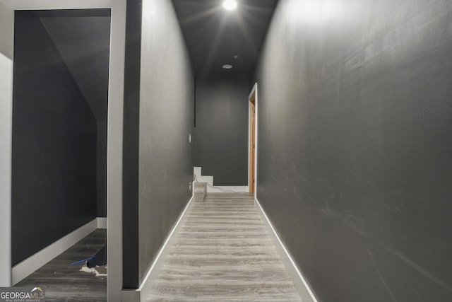 cinema room with baseboards and wood finished floors