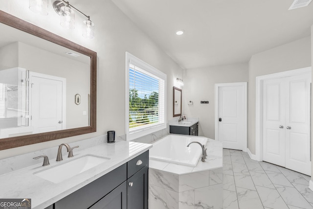 bathroom with marble finish floor, visible vents, a sink, and a bath