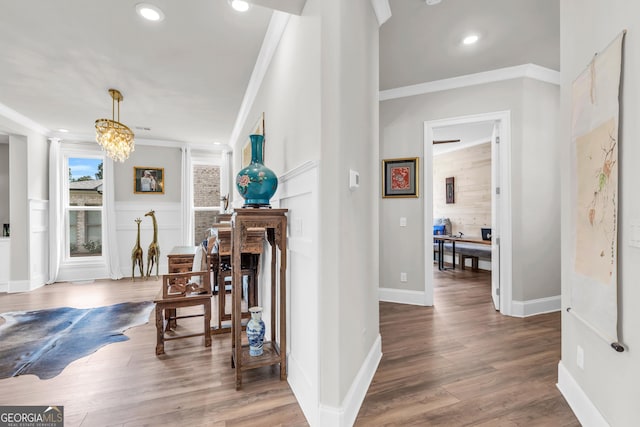 corridor featuring crown molding, recessed lighting, baseboards, and wood finished floors