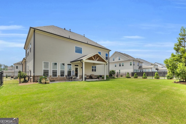 rear view of property featuring a fenced backyard, a patio area, and a yard