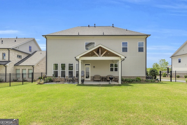 back of house with a yard, a patio, and a fenced backyard