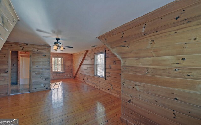 221 Laurel Cir, Dahlonega, GA 30533 - additional living space with wooden walls, a ceiling fan, and hardwood / wood-style floors