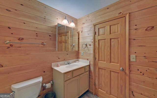 221 Laurel Cir, Dahlonega, GA 30533 - bathroom with wooden walls, toilet, and vanity