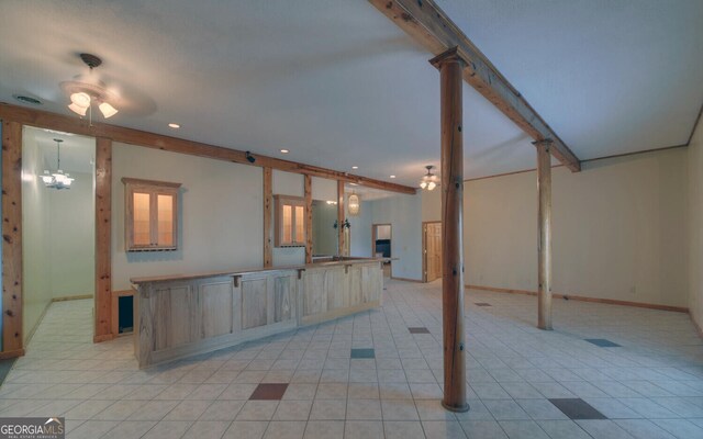 221 Laurel Cir, Dahlonega, GA 30533 - kitchen with visible vents, beamed ceiling, light brown cabinets, a spacious island, and light tile patterned floors