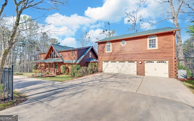 221 Laurel Cir, Dahlonega, GA 30533 - view of front of home featuring driveway, a garage, and metal roof