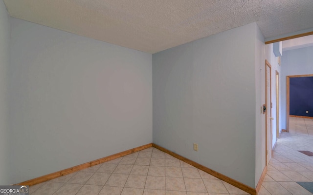 221 Laurel Cir, Dahlonega, GA 30533 - empty room with light tile patterned flooring, baseboards, and a textured ceiling