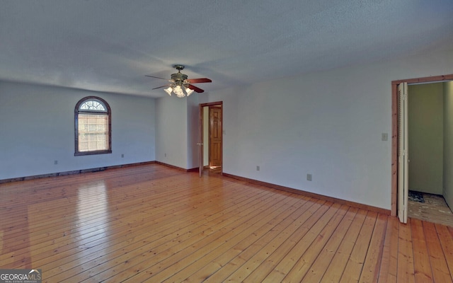 221 Laurel Cir, Dahlonega, GA 30533 - empty room with baseboards, a textured ceiling, light wood-style flooring, and a ceiling fan