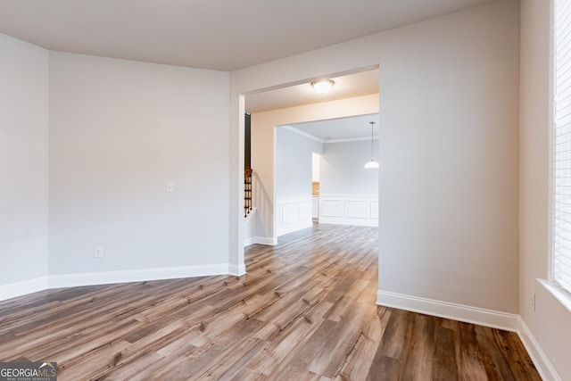 spare room featuring wood finished floors and stairs