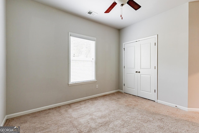 unfurnished bedroom with carpet flooring, multiple windows, and baseboards