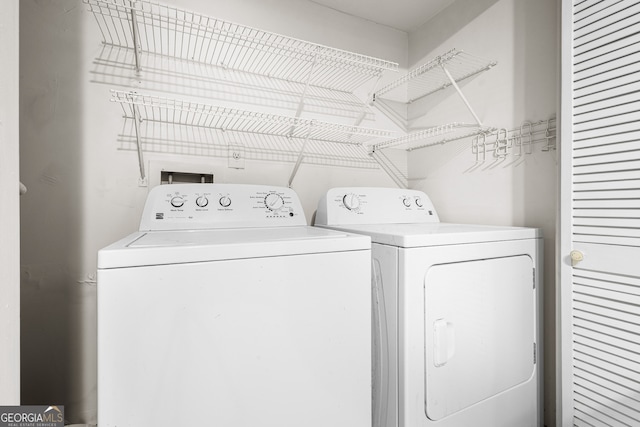 laundry room featuring washing machine and clothes dryer and laundry area