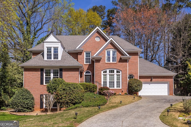traditional home with brick siding, concrete driveway, a garage, and a shingled roof