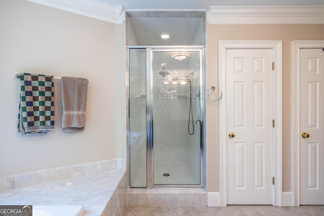 bathroom featuring tile patterned floors, crown molding, and a shower stall